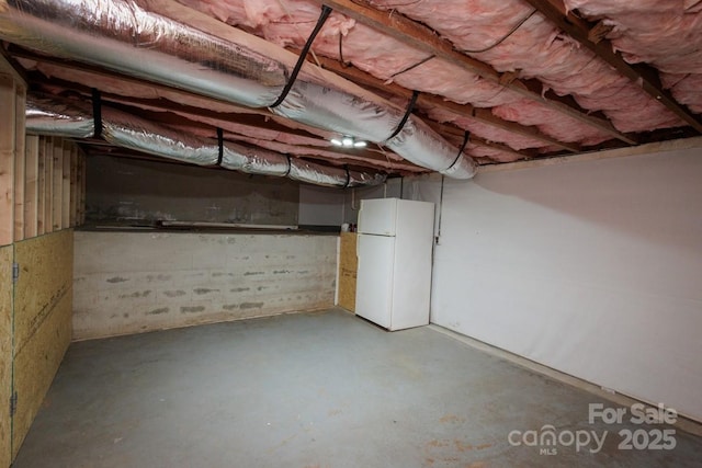 basement featuring white fridge