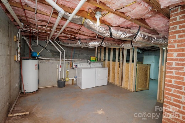 basement with white refrigerator, water heater, and washing machine and clothes dryer