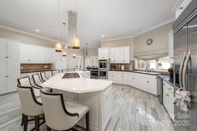 kitchen featuring hanging light fixtures, decorative backsplash, stainless steel appliances, and a kitchen island