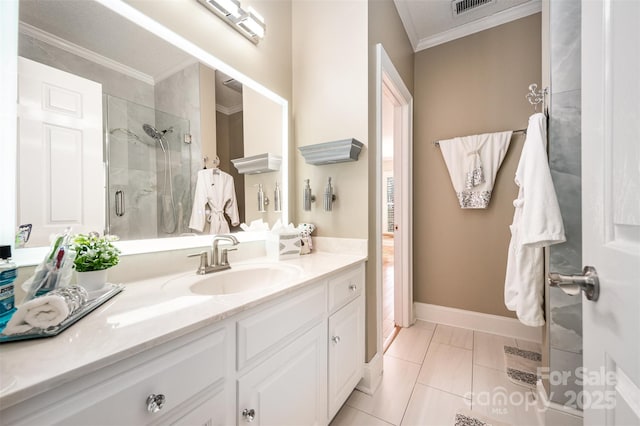 bathroom with an enclosed shower, vanity, ornamental molding, and tile patterned flooring