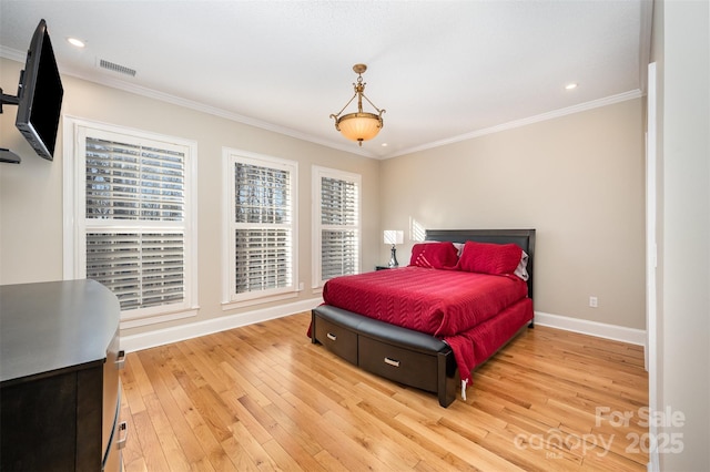 bedroom with light wood-type flooring and crown molding