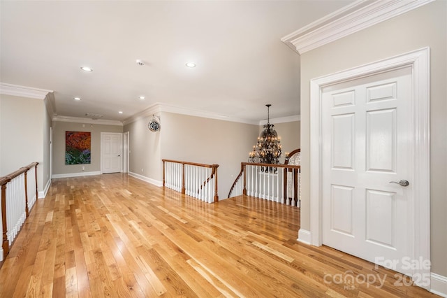 interior space with crown molding, an inviting chandelier, and light hardwood / wood-style flooring