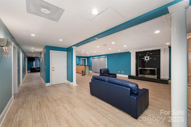 living room featuring light hardwood / wood-style floors and decorative columns