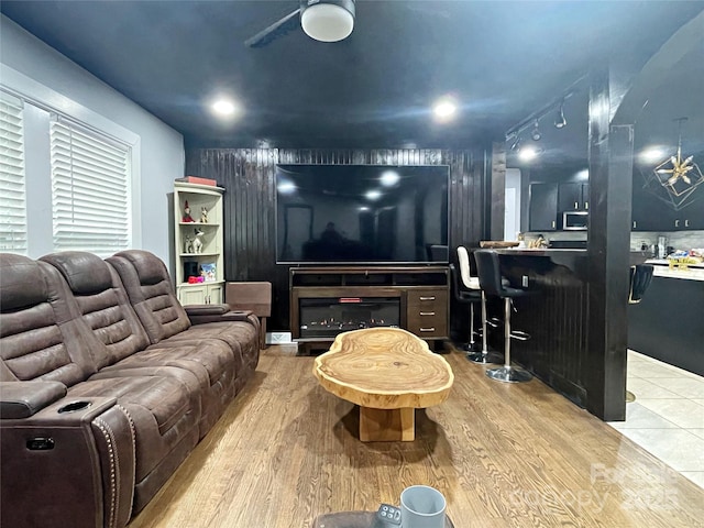 living room featuring ceiling fan and light wood-type flooring