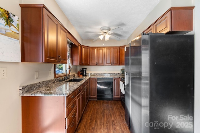 kitchen featuring sink, black dishwasher, stainless steel refrigerator, light stone countertops, and dark hardwood / wood-style flooring