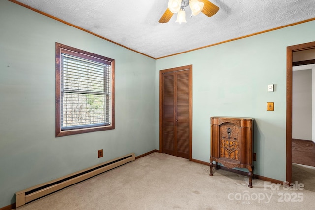 unfurnished bedroom featuring a textured ceiling, a closet, a baseboard heating unit, ceiling fan, and light carpet