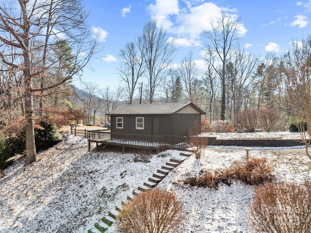 view of snow covered back of property