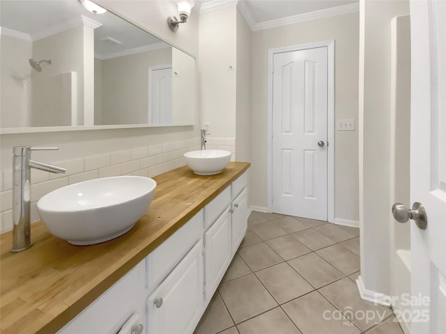 bathroom with tile patterned floors, decorative backsplash, vanity, and ornamental molding