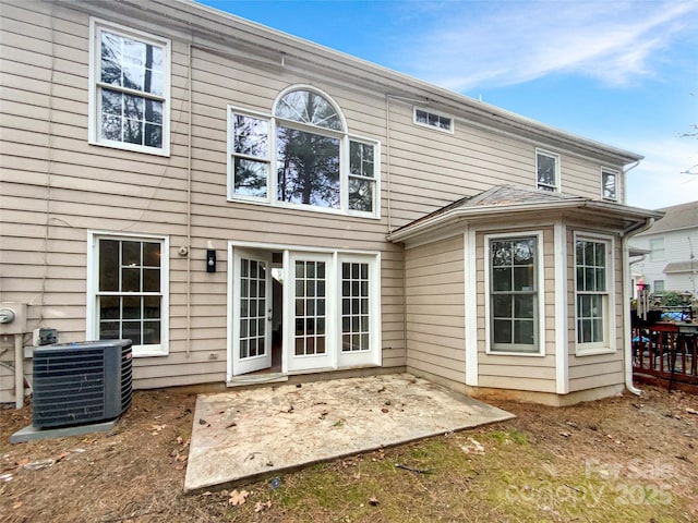 rear view of property featuring central AC unit