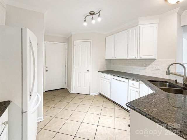 kitchen featuring sink, tasteful backsplash, dark stone counters, white appliances, and white cabinets