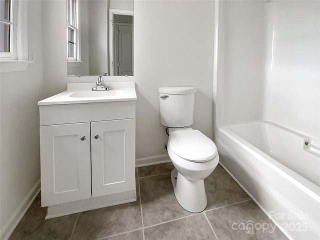 full bathroom featuring tile patterned floors, vanity, toilet, and shower / washtub combination