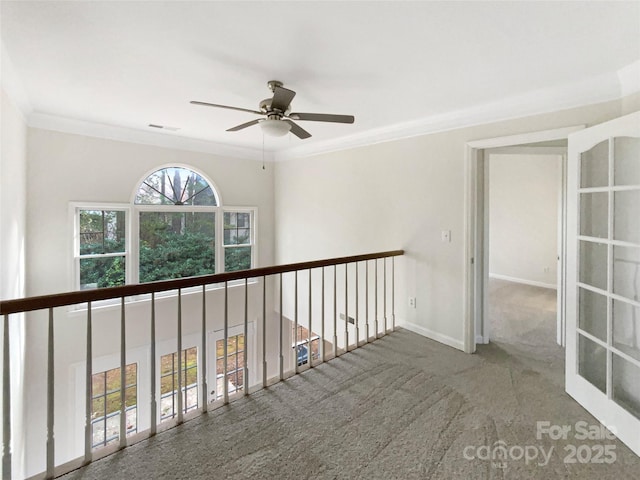 corridor featuring ornamental molding and carpet floors