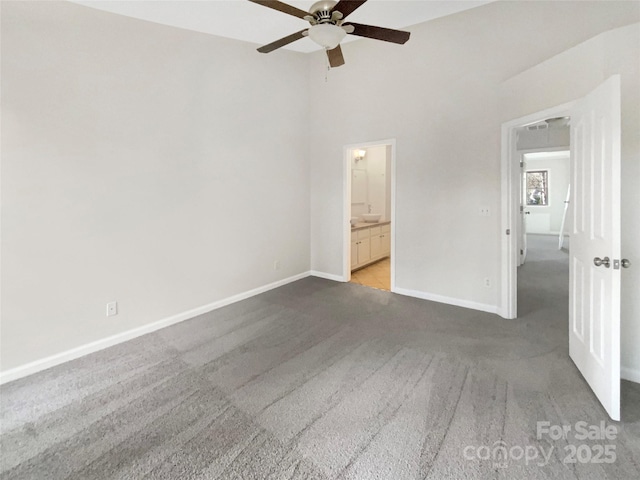 unfurnished bedroom with connected bathroom, ceiling fan, and carpet