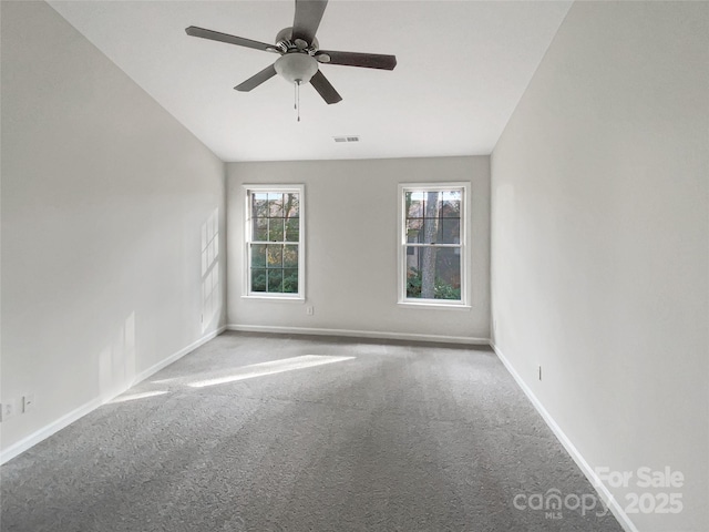 carpeted spare room featuring ceiling fan