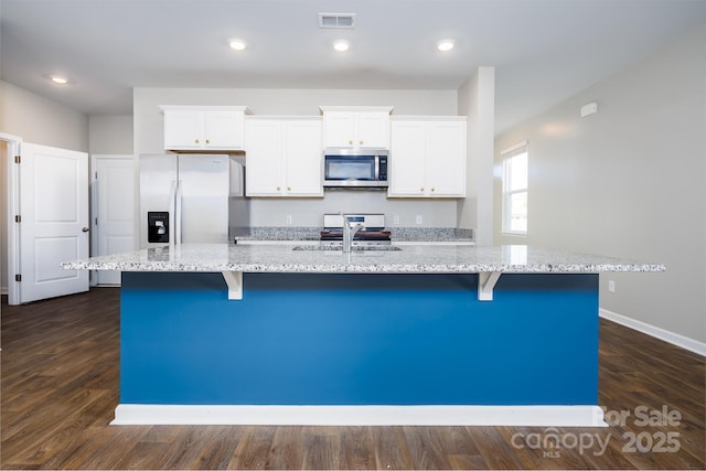 kitchen featuring a center island with sink, white cabinets, stainless steel appliances, and sink