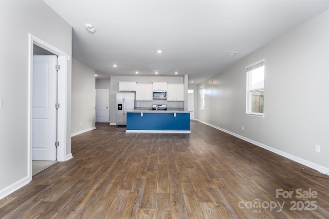 unfurnished living room featuring dark wood-type flooring