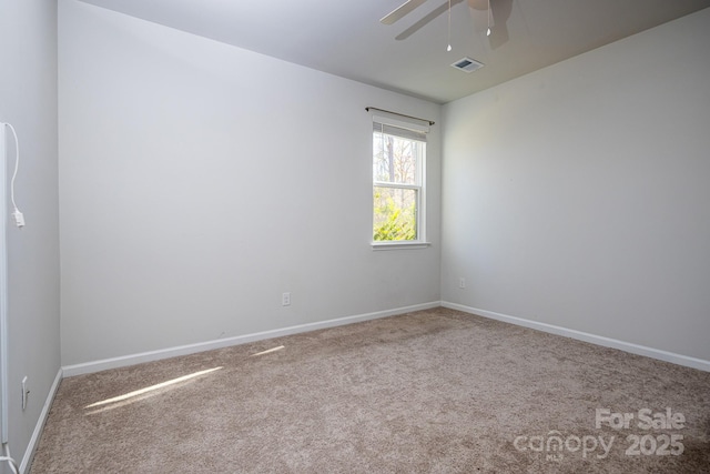 carpeted spare room with ceiling fan