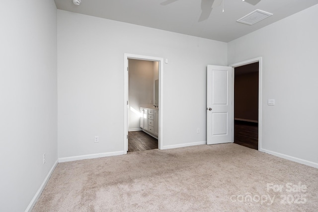 unfurnished bedroom featuring carpet flooring, ceiling fan, and ensuite bathroom