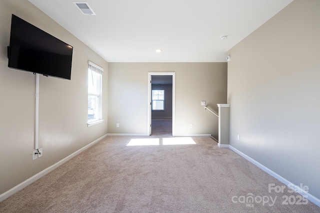 unfurnished living room with light colored carpet