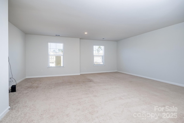 unfurnished room with light colored carpet