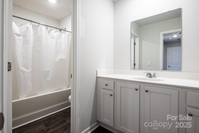 full bathroom with shower / tub combo, vanity, hardwood / wood-style flooring, and toilet