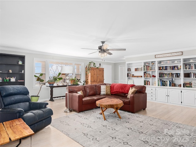 living room with light wood-style floors, crown molding, and ceiling fan