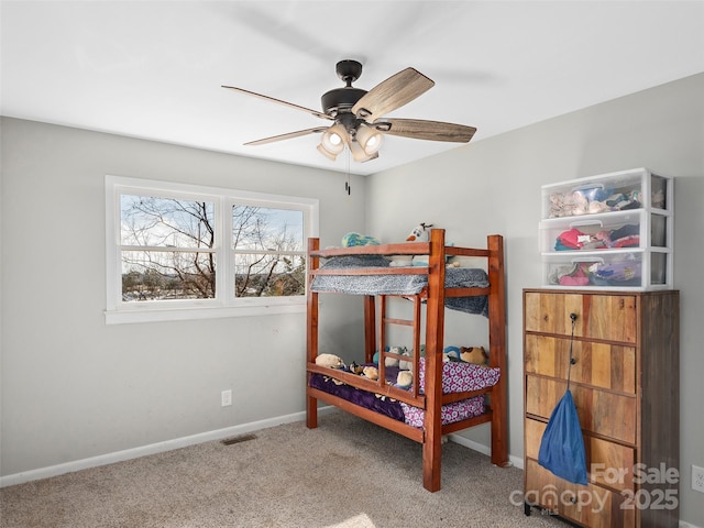 bedroom featuring a ceiling fan, baseboards, visible vents, and carpet flooring