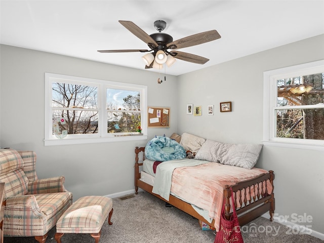 carpeted bedroom featuring visible vents, ceiling fan, and baseboards
