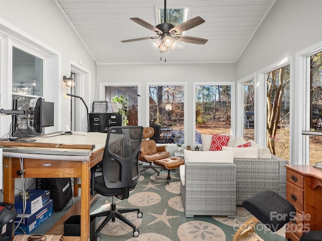 sunroom / solarium featuring a healthy amount of sunlight, ceiling fan, and vaulted ceiling