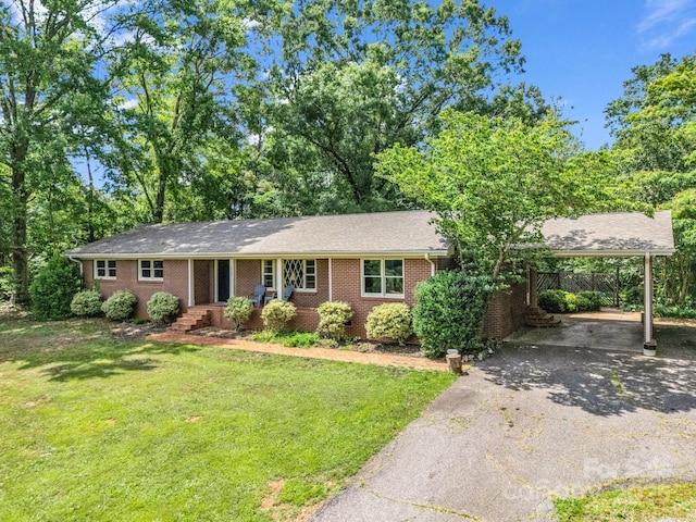 1737 Whitesides Rd, Forest City, NC 28043 - ranch-style home featuring asphalt driveway, a front yard, brick siding, and an attached carport