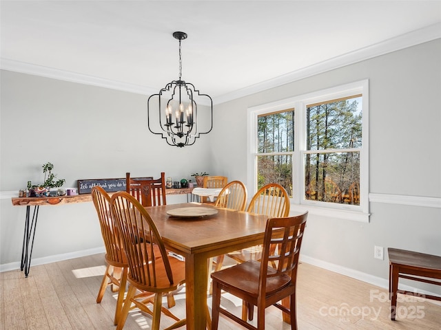 1737 Whitesides Rd, Forest City, NC 28043 - dining space featuring light wood-style flooring, a chandelier, and crown molding