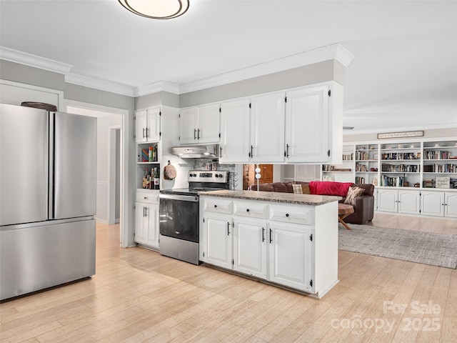1737 Whitesides Rd, Forest City, NC 28043 - kitchen with stainless steel appliances, under cabinet range hood, ornamental molding, white cabinetry, and light wood-style flooring