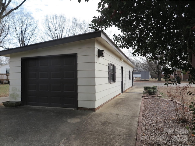 view of side of home featuring a garage and an outdoor structure