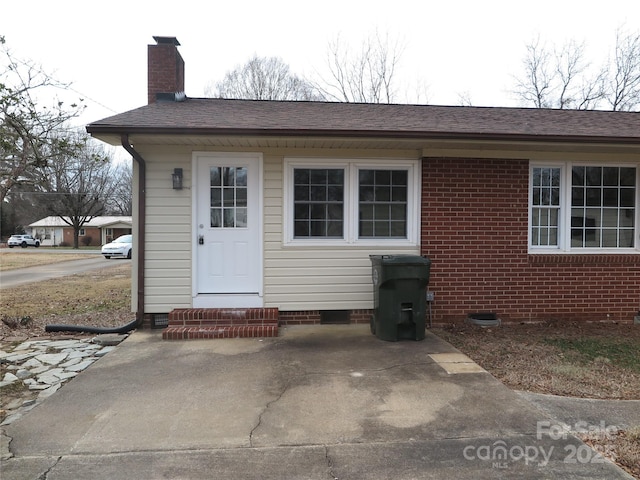 entrance to property with a patio area