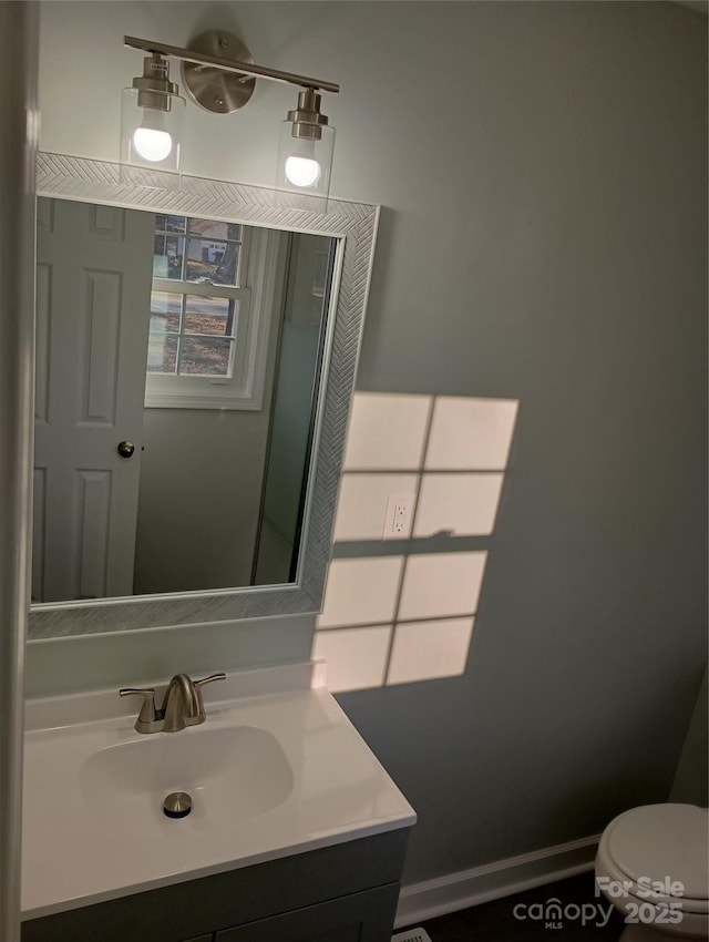 bathroom with vanity and toilet