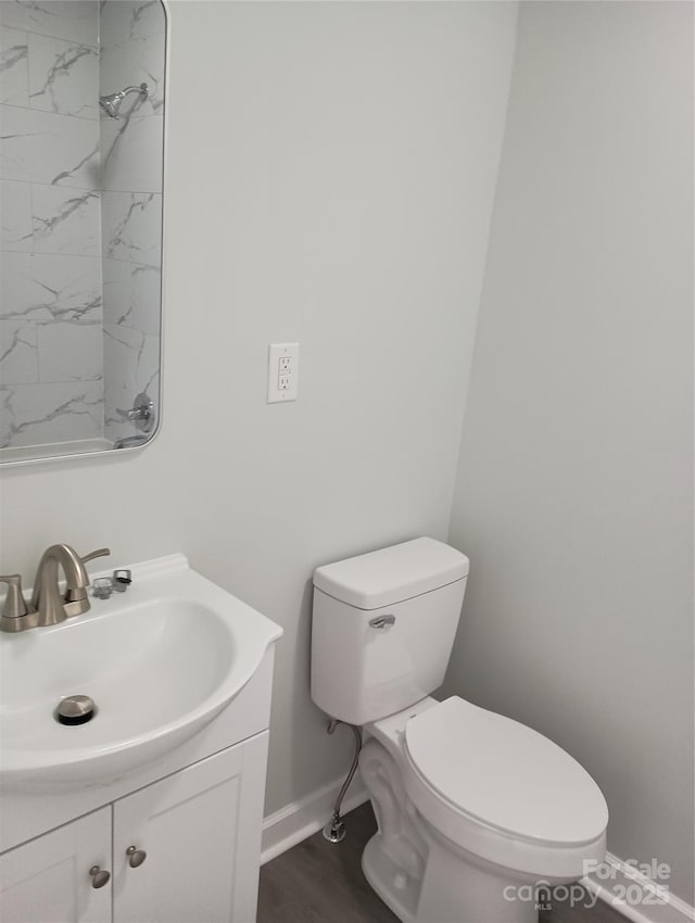 bathroom featuring vanity, toilet, and hardwood / wood-style floors