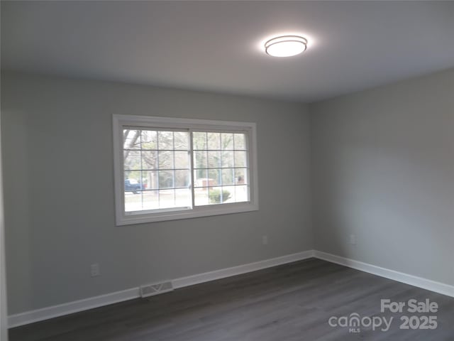 empty room featuring dark wood-type flooring