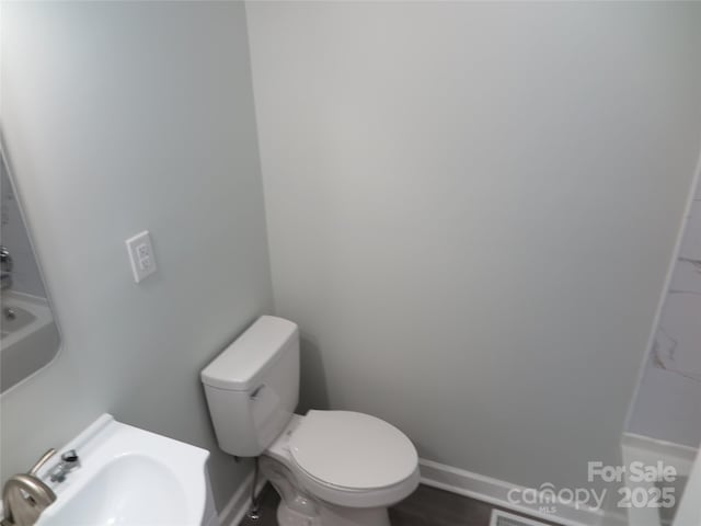 bathroom featuring sink and toilet