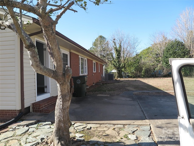 view of side of home with a patio and cooling unit