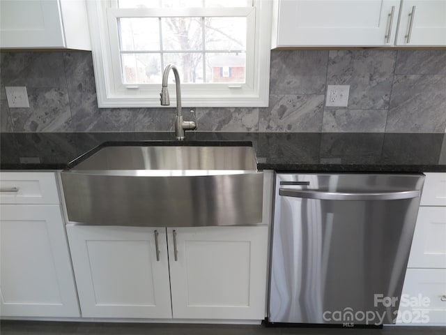 kitchen featuring sink, decorative backsplash, stainless steel dishwasher, and white cabinets