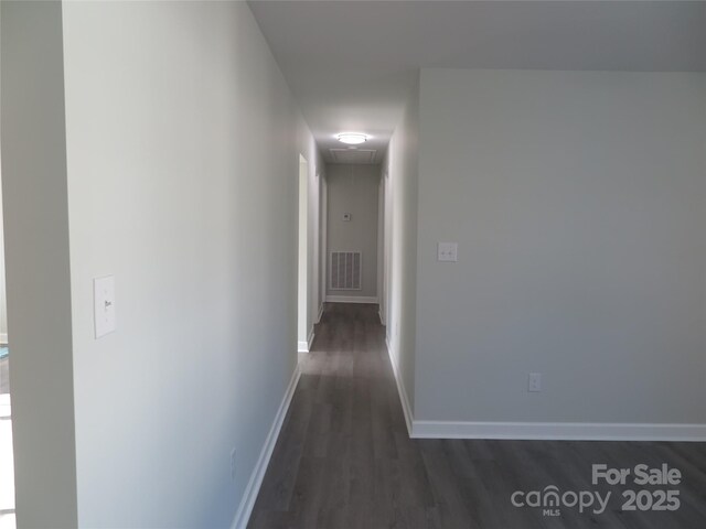 corridor with dark hardwood / wood-style floors