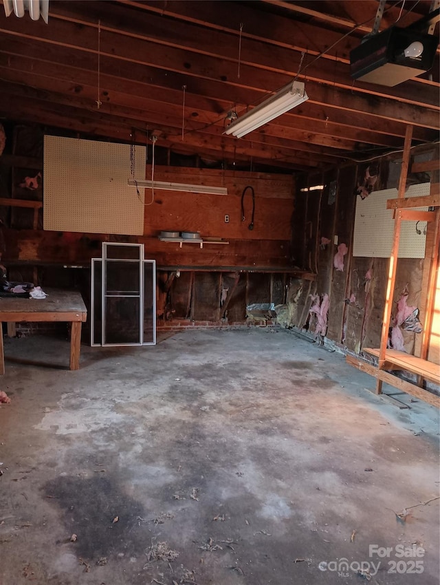 interior space with a garage door opener and a workshop area