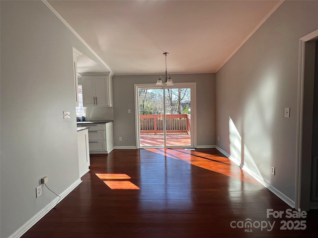 unfurnished dining area featuring a notable chandelier and dark hardwood / wood-style flooring