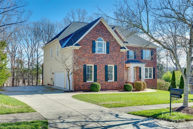 view of front of property featuring a front yard and a garage