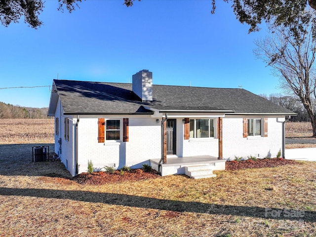 ranch-style home featuring central AC unit