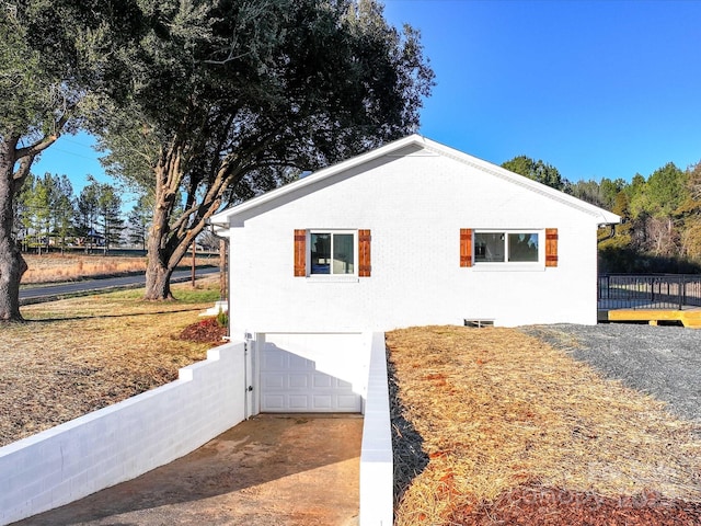 view of side of home with a garage and a wooden deck