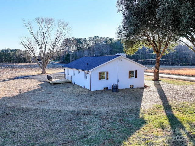 view of property exterior with central AC and a deck