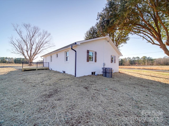 view of side of home featuring a wooden deck