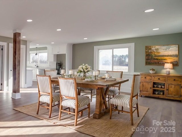 dining area with hardwood / wood-style floors and sink