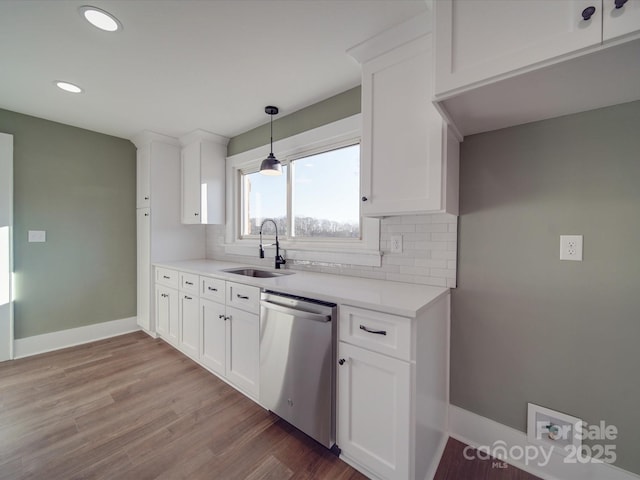 kitchen with white cabinets, dishwasher, and sink